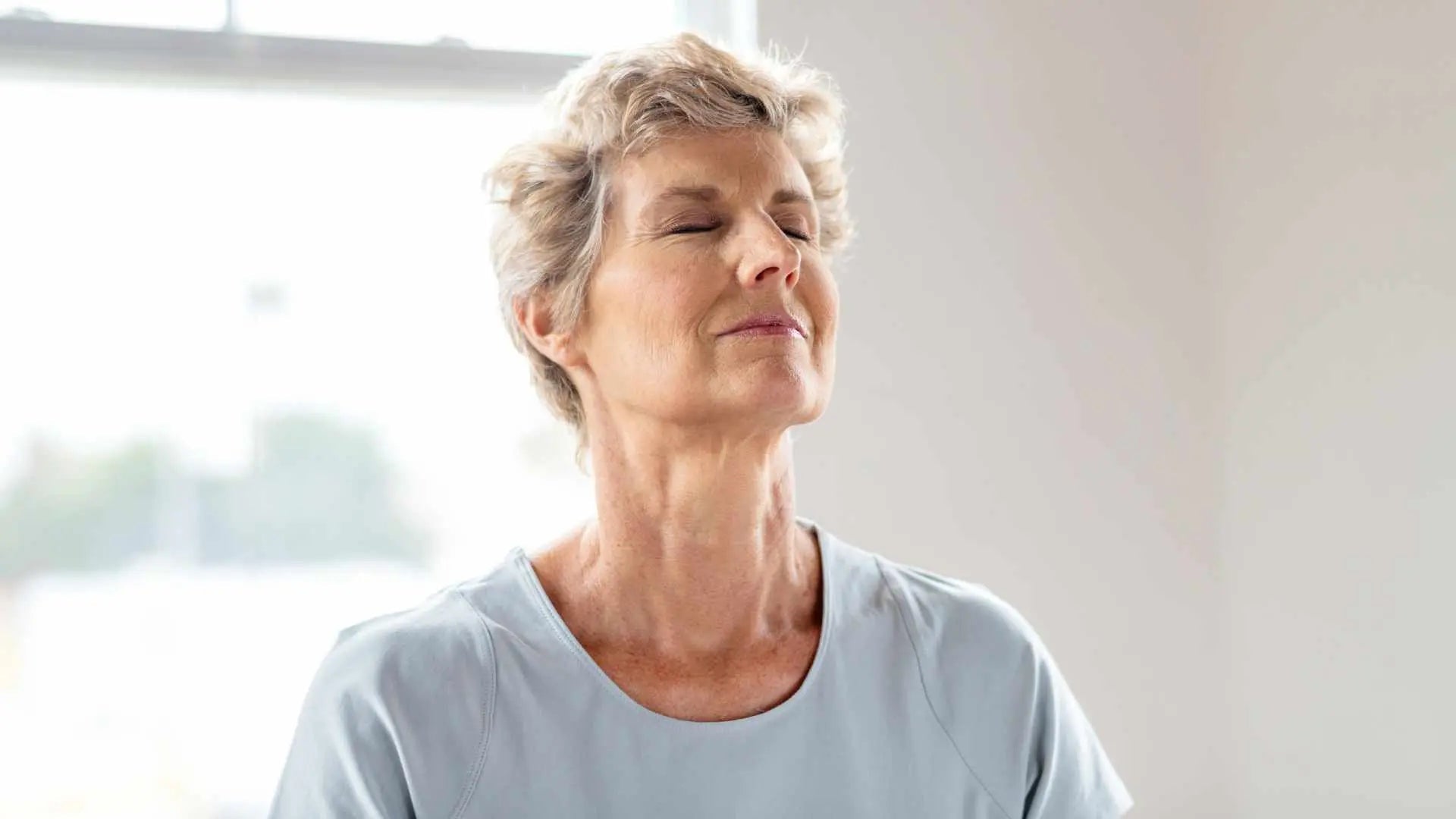 Woman practicing calm breathing exercise to help reduce stress and support healthy cortisol balance