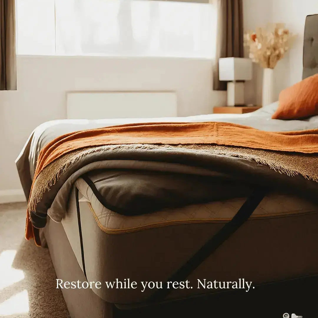 Earthbound Grounding Mattress Pad — angled bed view with elastic straps