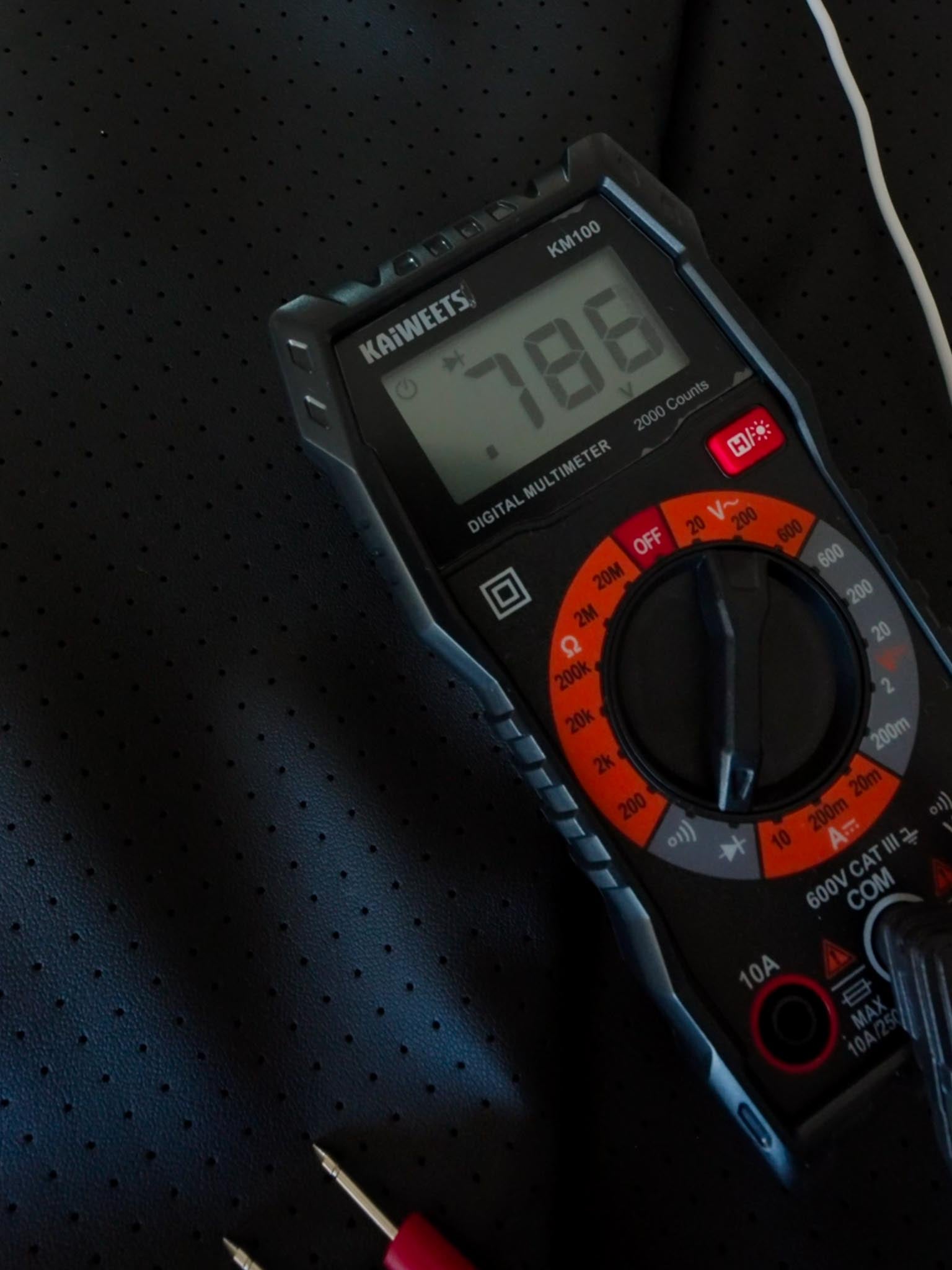 Digital multimeter testing grounding mat voltage