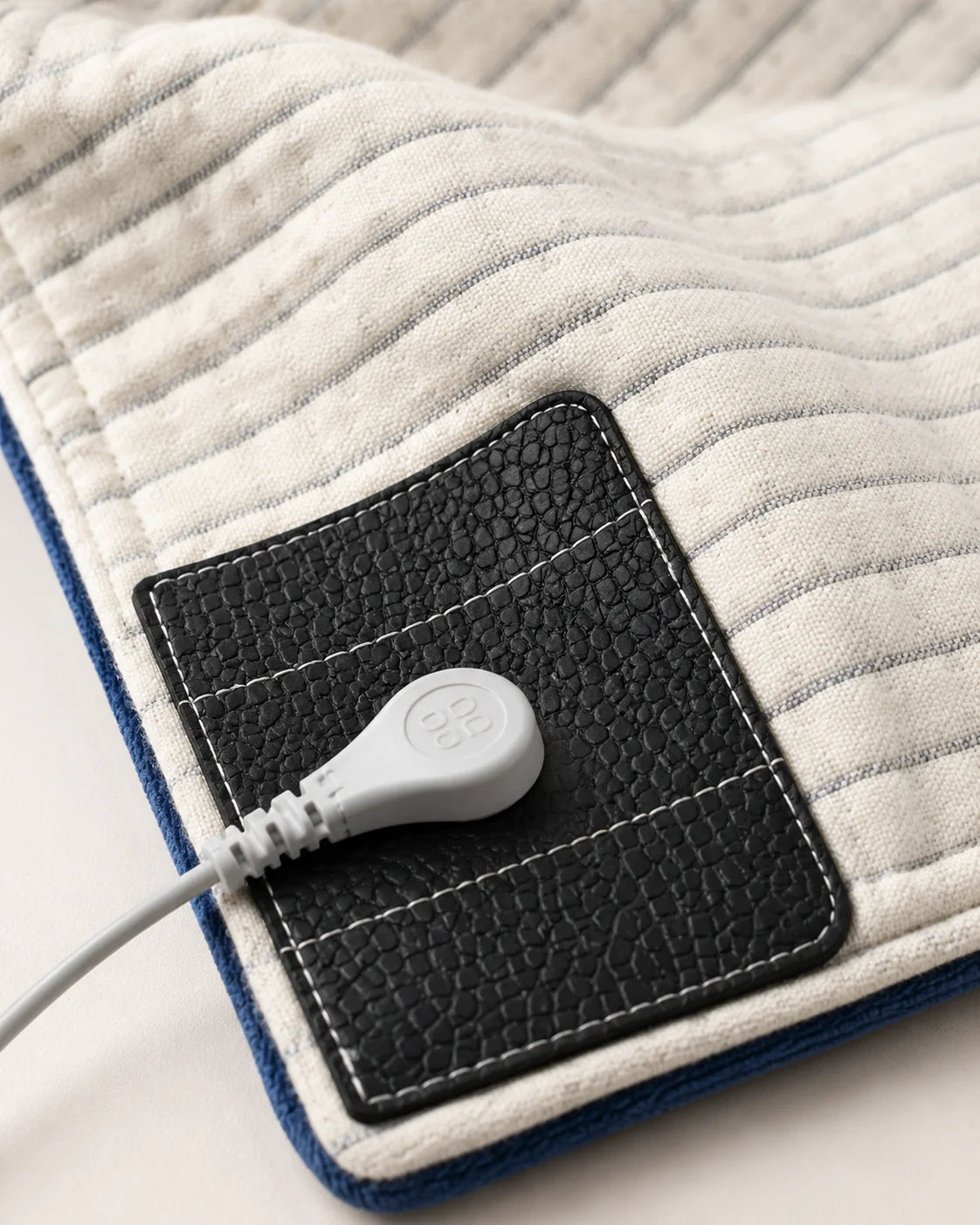 Grounding blanket corner close-up showing the snap connector