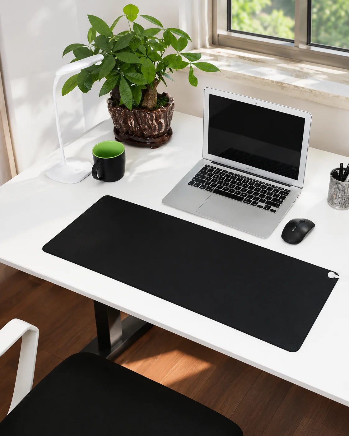 Grounding mat under a laptop on a standing desk