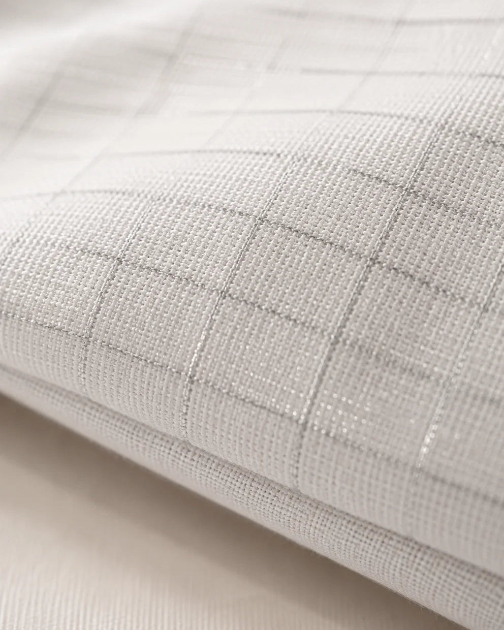 Close-up of the pillow cover's woven grid fabric