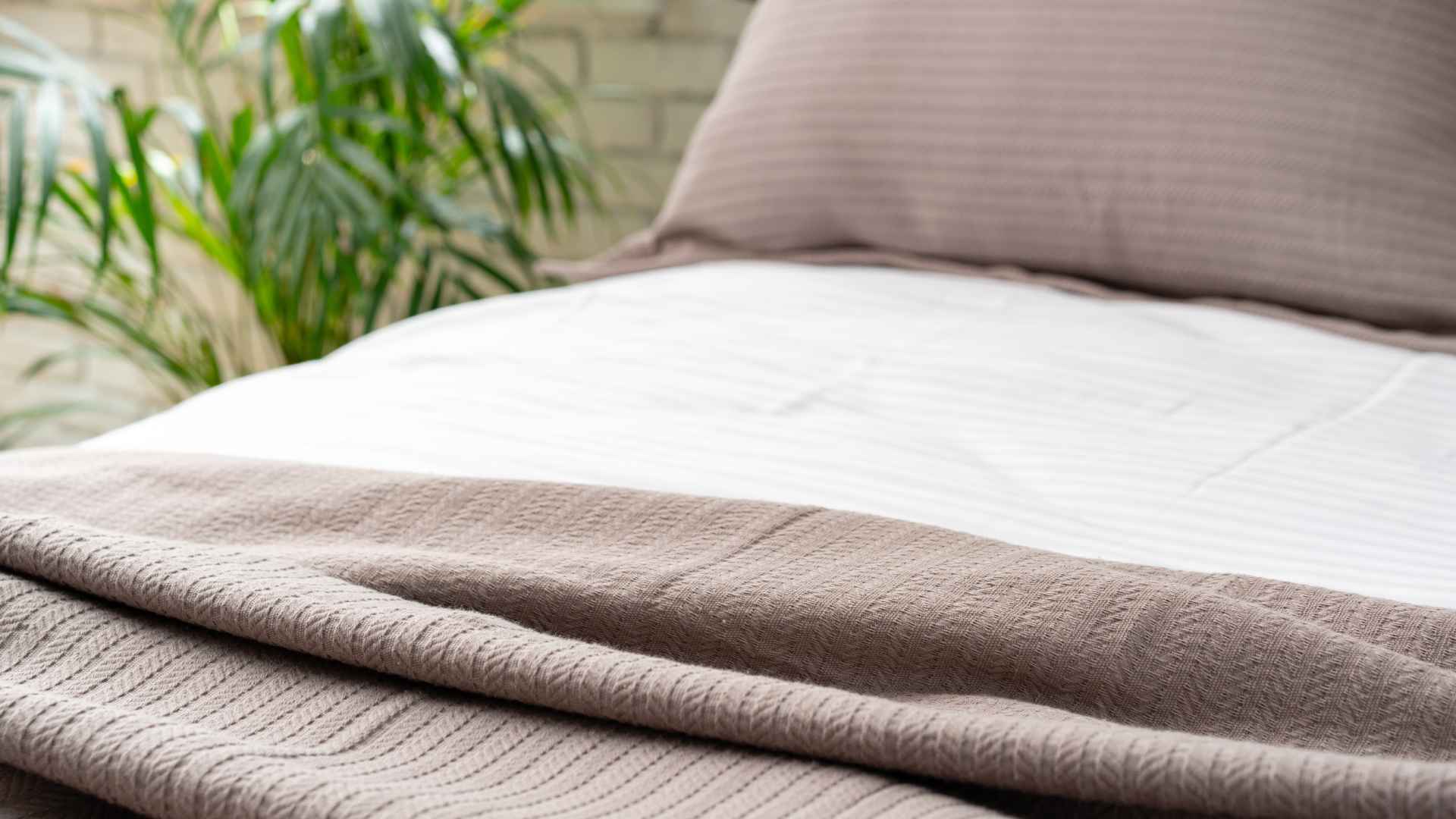 Grounding sheet placed on a bed showing conductive fabric used for earthing during sleep