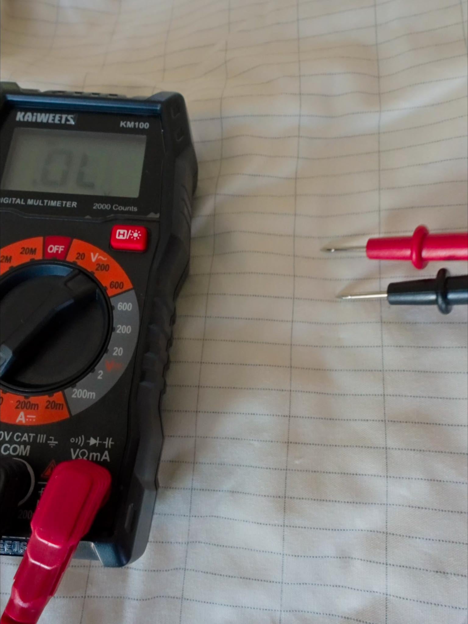 Multimeter confirming grounded sheet voltage drop