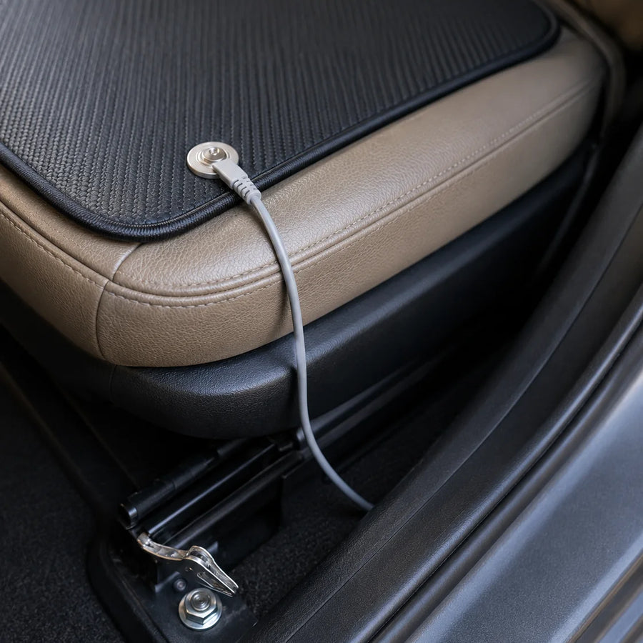 Car seat mat with cord connected at the seat base